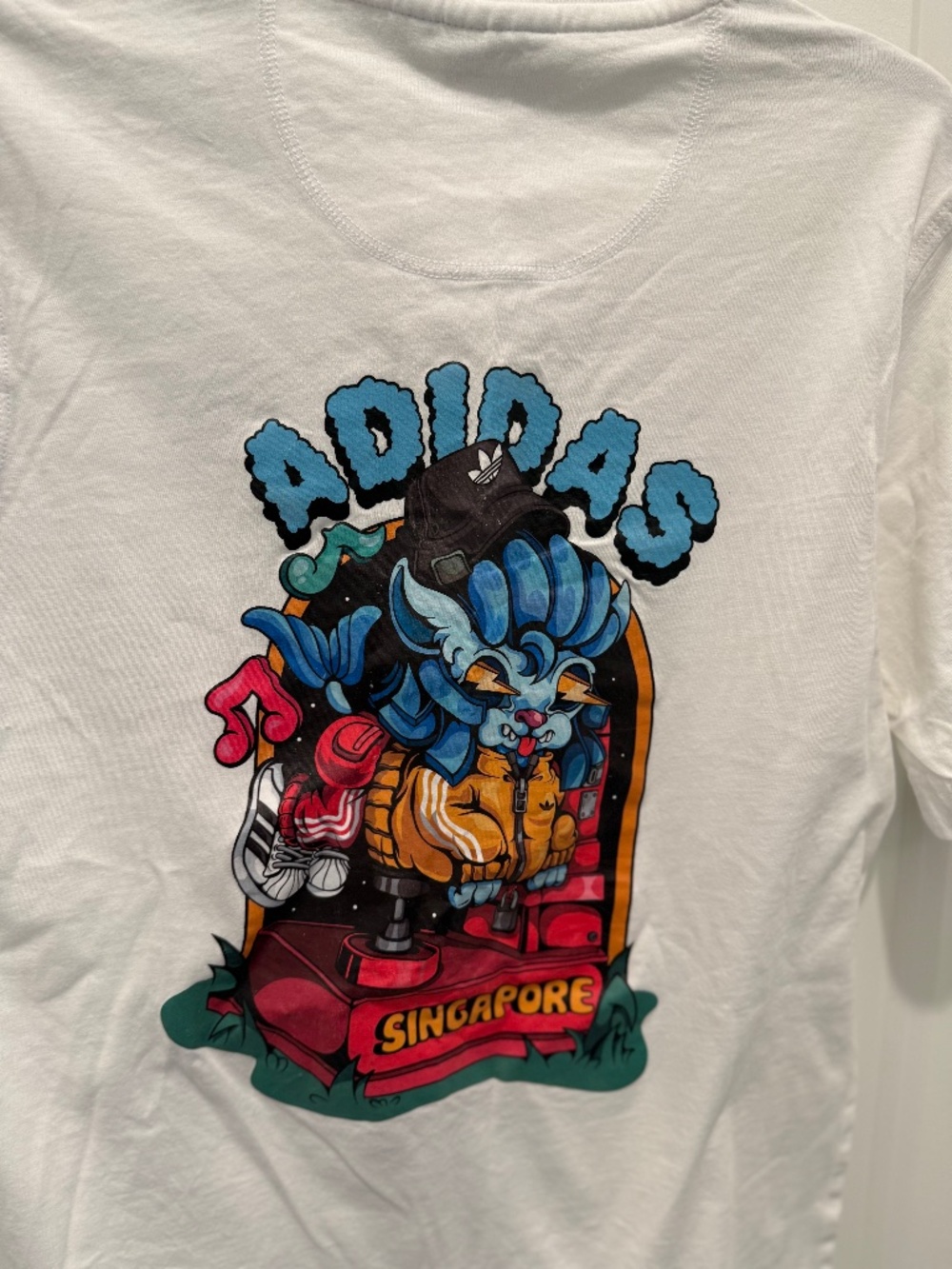 ADIDAS - THIS IS A WHITE GRAPHIC T-SHIRT THAT FEATURES AN ILLUSTRATED CREATURE